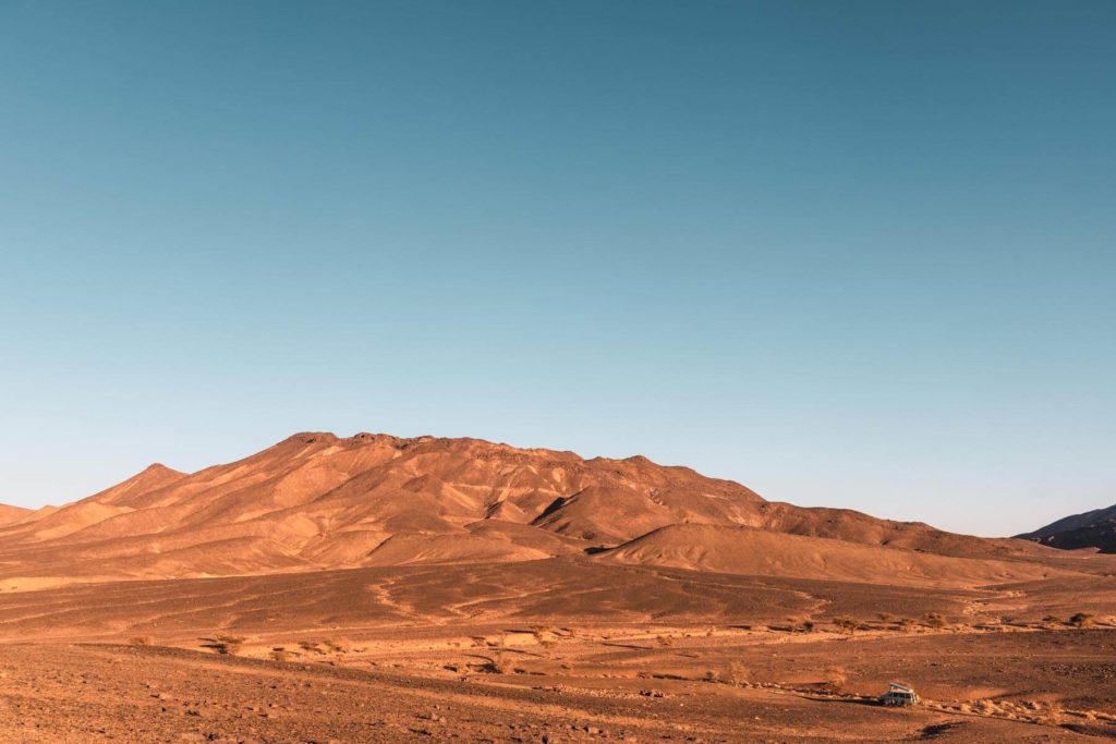 Marokko Wüstentour Übernachtungsplatz vor bergiger Wüstenkulisse
