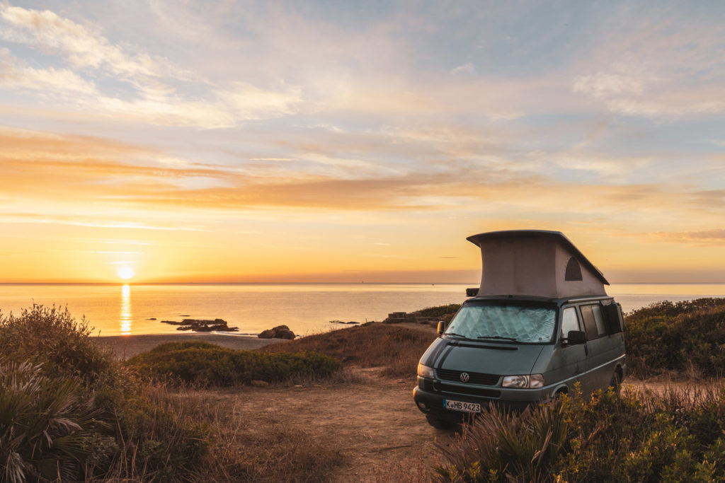 Camping in Spanien mit dem VW Bus Camper T4 California mit Aufstelldach direkt am Meer bei Sonnenaufgang